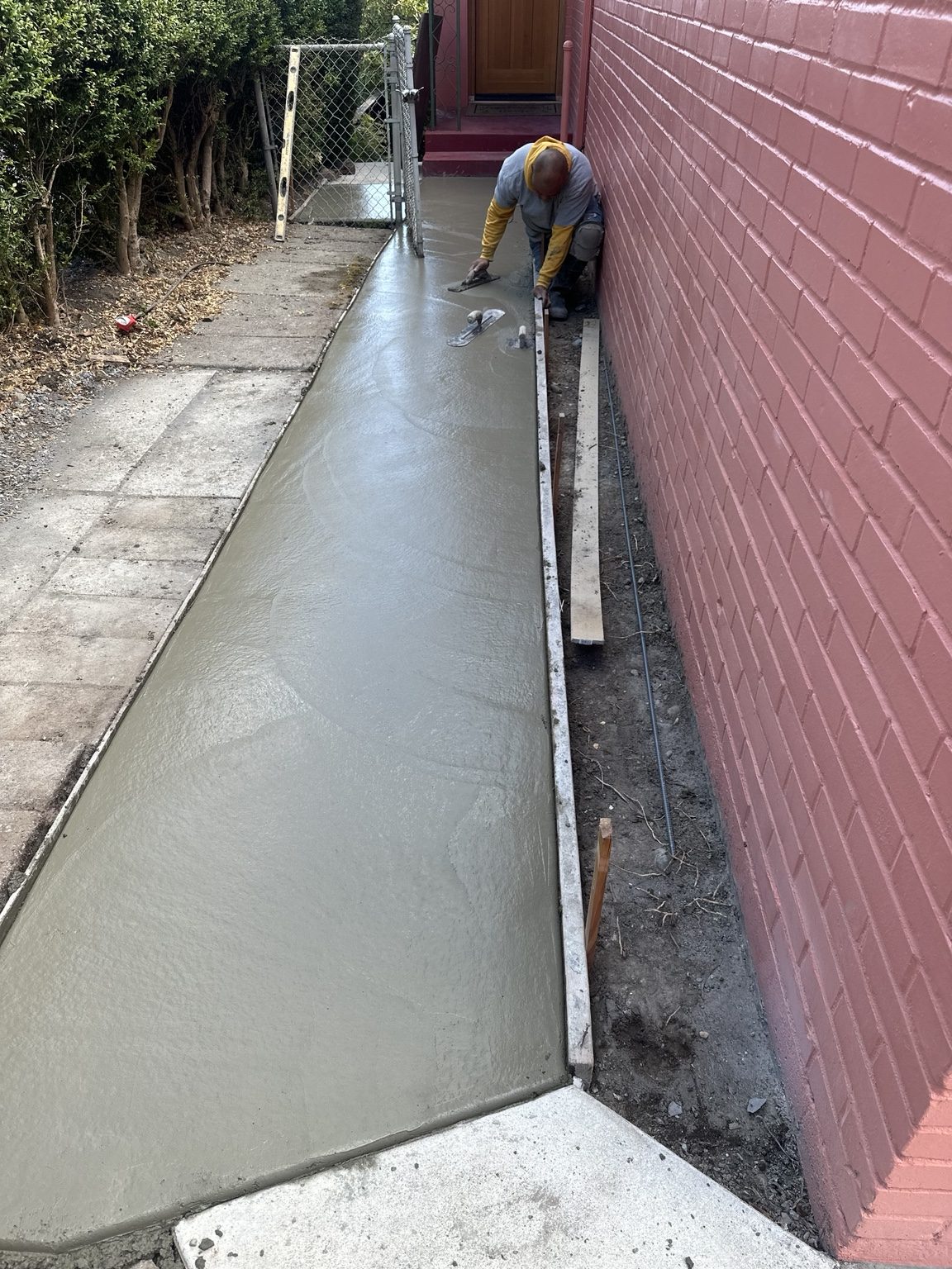 Concrete walkway being finished during a Peak Stone Concrete project
